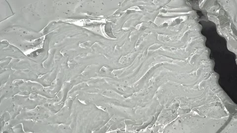 Smearing transparent gel on a white surface Stock Footage 252195609