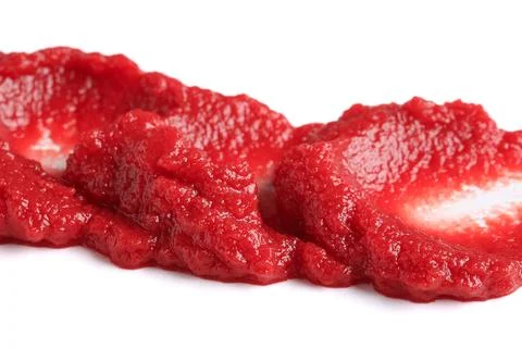 Smears of red tomato paste on white background Stock Photos