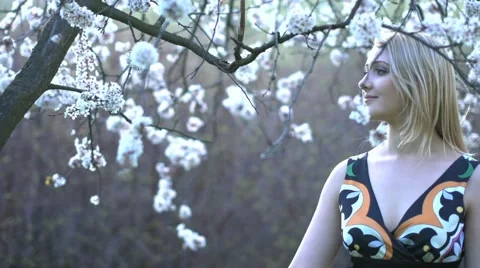 Smelling flowers in springtime Stock Footage 64817821