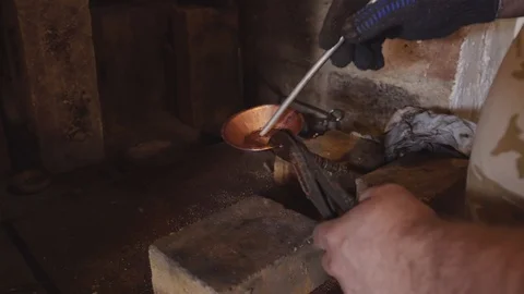 Smelting of tin in the article of copper. Stock Footage 94937734