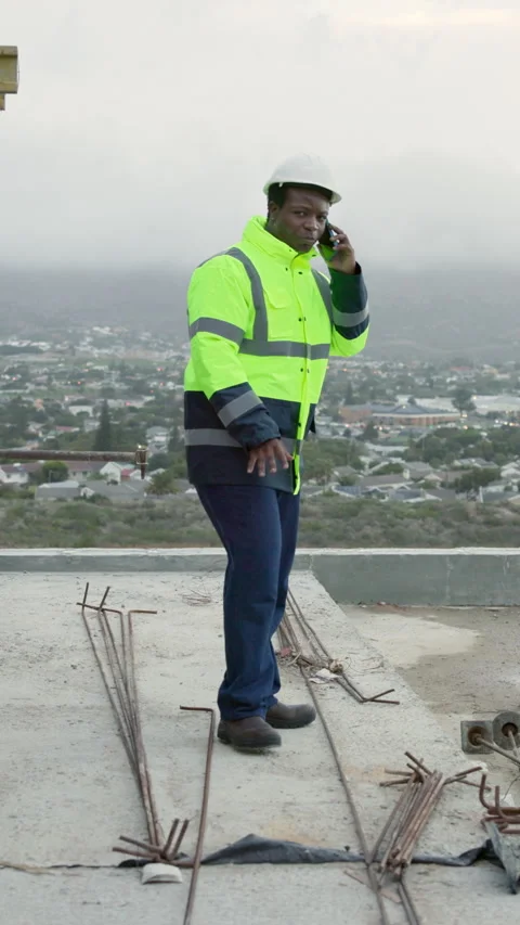 Smile, black man and engineer on rooftop with phone call, inspection and Stock Footage 338035433