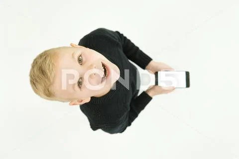 The smile boy stand with a smartphone. View from above Stock Photos