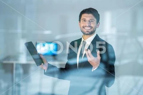 The smile businessman stand with the tablet over the window Stock Photos