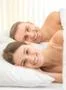 The smile couple lay on the bed Photo