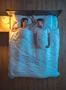 The smile couple lie on the bed. evening night time. view from above Photo