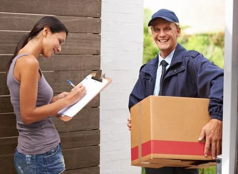 Smile, delivery and woman signing for a package or using pen from postman for Stock Photos