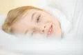 The smile girl lay in the bed Photo