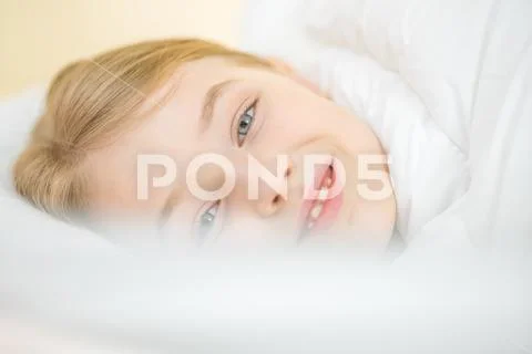 The smile girl lay in the bed Stock Photos