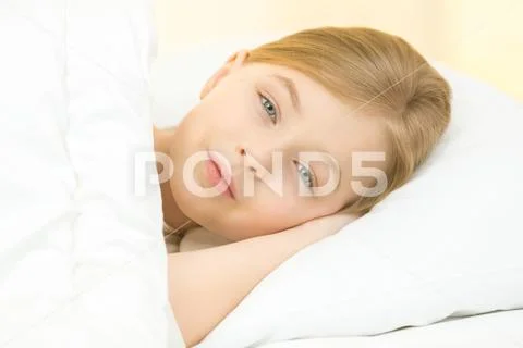 The smile girl lay on the bed Stock Photos