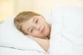 The smile girl lay on the bed Photo