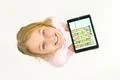The smile girl stand with a tablet. View from above Photo