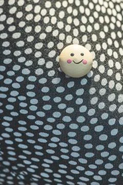 Smile icon on textile surface with points. Stock Photos