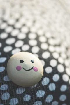 Smile icon on textile surface with points. Stock Photos