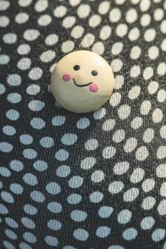 Smile icon on textile surface with points. Stock Photos