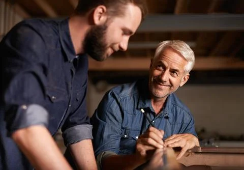 Smile, learning and carpenter with apprentice in training, man teaching Stock Photos