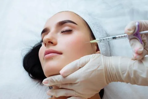 Smile lifting and lip augmentation. Beautician doctor hands doing beauty Stock Photos