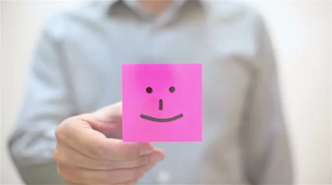 Smile. A man sticks a note on transparent screen Stock Footage 67829981