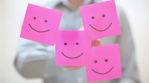 Smile. A man sticks a note on transparent screen Stock Footage 68088739