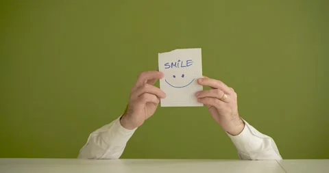 " SMILE" The man's mini picks up a sheet where it is written Stock Footage 267090349