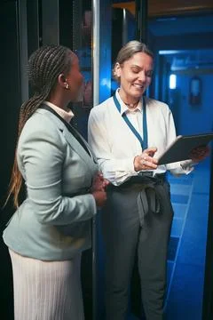 Smile, people and programming with tablet in server room for research, coding Stock-Fotos