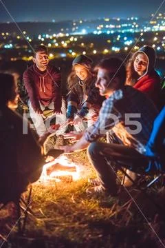 The smile people hold hands near the bonfire. night time Stock Photos