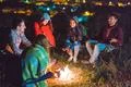 The smile people hold hands near the bonfire. night time Photo