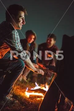The smile people warming hands near the bonfire. night time Stock Photos