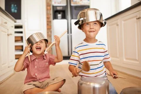 Smile, pots and playing with children in kitchen for imagination, fantasy and Stock Photos