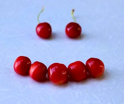 A smile of red cherry Stock Photos