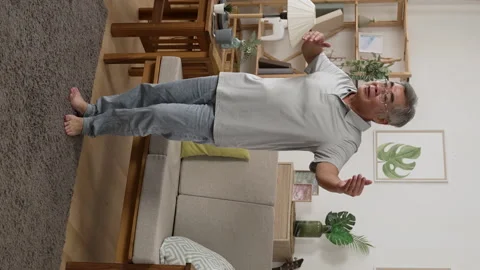 Smile senior romantic man dancing at home alone Stock Footage 229621038