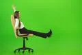 The smile woman fun on the chair on the green background Photo