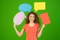 The smile woman hold a dialog signs on the green background Photo