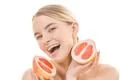 The smile woman holding a grapefruit on the white background Photo