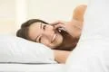The smile woman lay on the bed and phone Photo