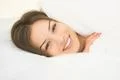 The smile woman lay in the white linens Photo