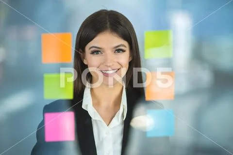 The smile woman near color stickers Stock Photos