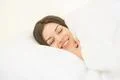 The smile woman sleeping in the white linens Photo