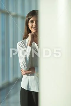 The smile woman stand near the column Stock Photos