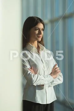 The smile woman stand near the column Stock Photos