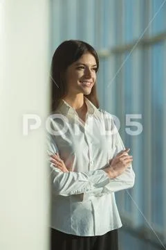 The smile woman stand near the column Stock Photos