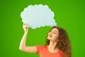 The smile woman stand with a virtual dialog on the green background Photo