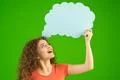 The smile woman stand with a virtual dialog on the green background Photo