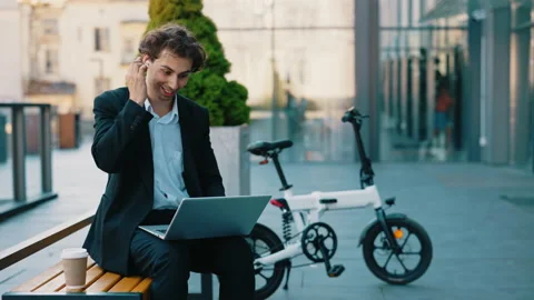 Smiled caucasian student sitting using laptop, having distant lecture, waving at Stock Footage 219772720