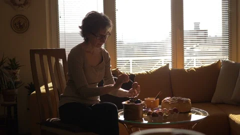 Smiled Мiddle-aged Lady Paints Easter Eggs At Sunset, Easter Atmosphere Video stock 128674559