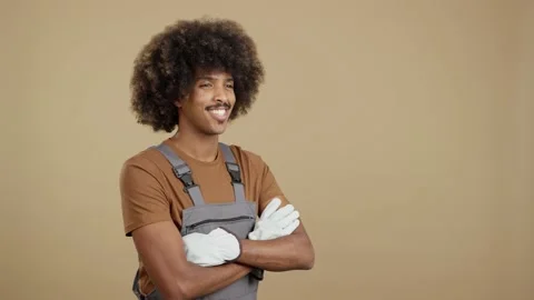 Smiley african man carpentry worker with tools and work uniform Stock Footage 238676612