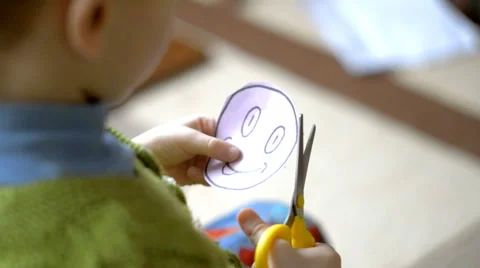 Smiley child cuts from the paper Stock Footage 60815751