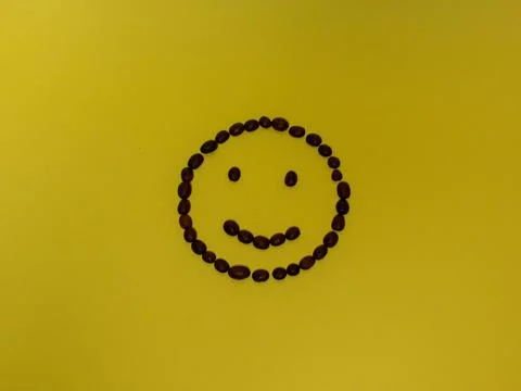 Smiley with coffee on a yellow background Stock Photos