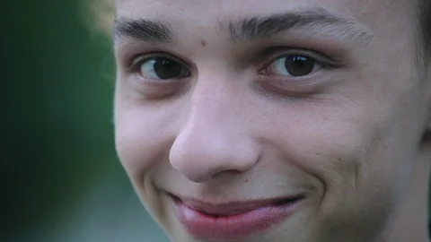 Smiley face closeup , young boy outdoors in the evening Stock Footage 96217011