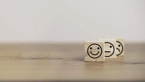 Smiley face in front of normal and sadness face which print screen on wooden Stock Photos