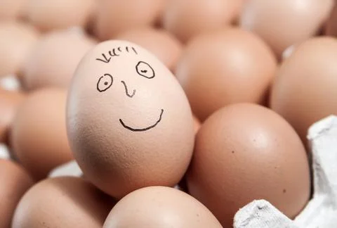 Smiley face on a raw egg Foto stock